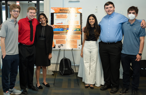 The RefuHome team during their poster presentation.